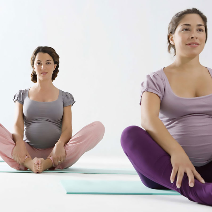 pregnant women doing yoga