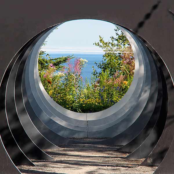 view of garden and water through circle sculpture