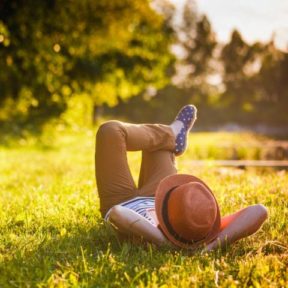 man relaxing on grass
