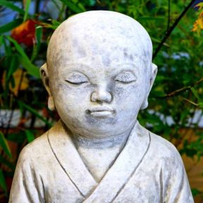statue of sweet looking boy meditating