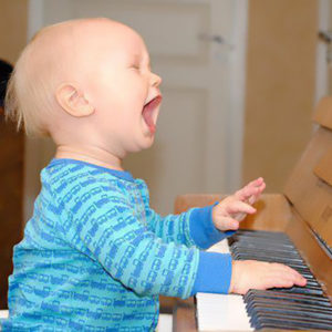 baby singing at piano