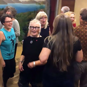 women singing and moving