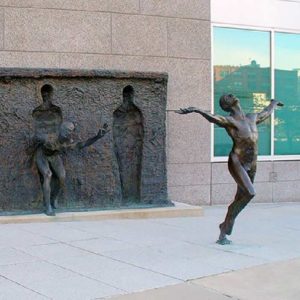 Sculpture of woman exuberantly bursting forward