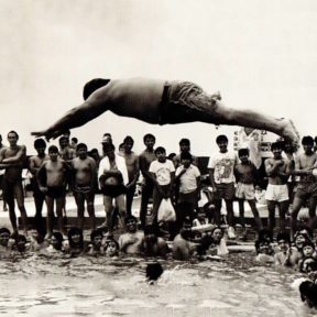 person diving out into water