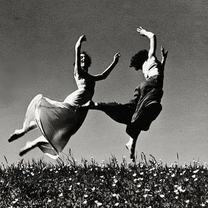 Jumping girls on a spring meadow by Hannes Killan