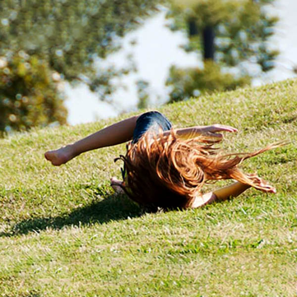 child rolling downhill